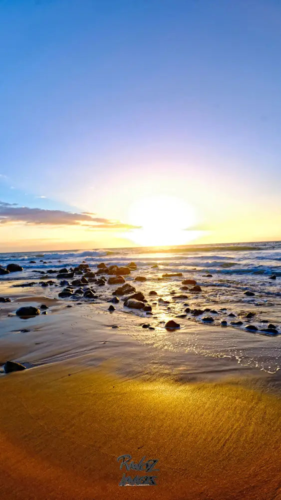 Dramatic sunburst light rays illuminating sandy beach Australian coast