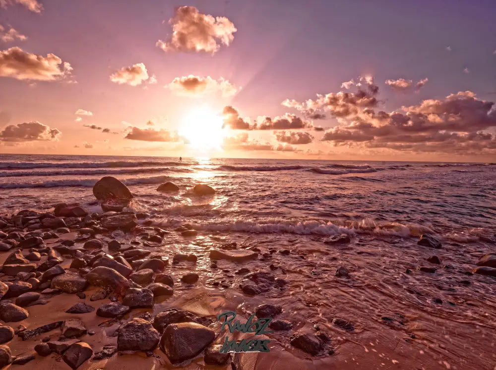 Stand-up paddleboarder on ocean at sunrise white light over water