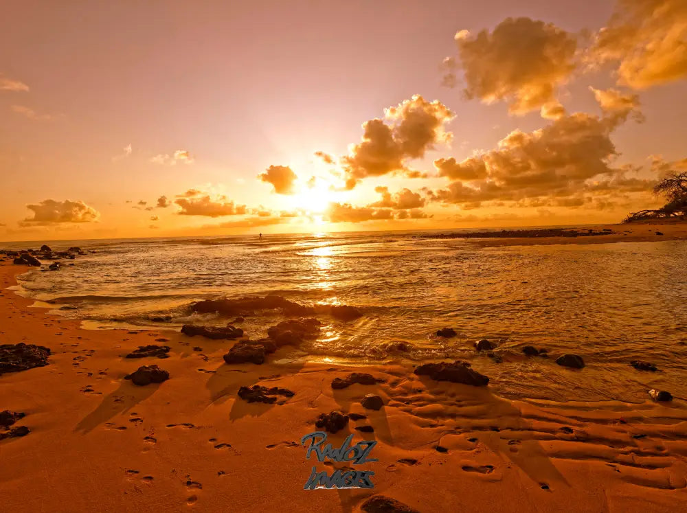 SUP paddler enjoying first light on outgoing tide golden morning