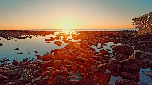 Volcanic red rocks illuminated by dawn sun rays Australian geological formation