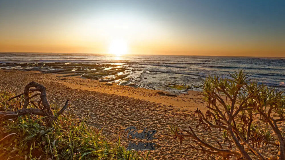 Fiery summer sunrise with blazing orange sky at Shelley Beach Sunshine Coast