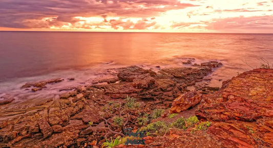 Dramatic red sunset sky over stormy Sunshine Coast morning seascape