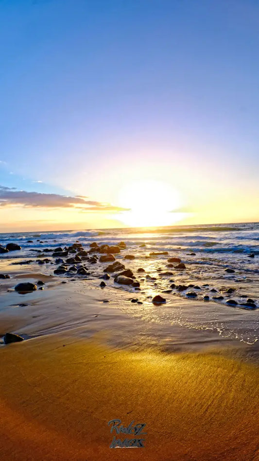 Dramatic sunburst light rays illuminating sandy beach Australian coast