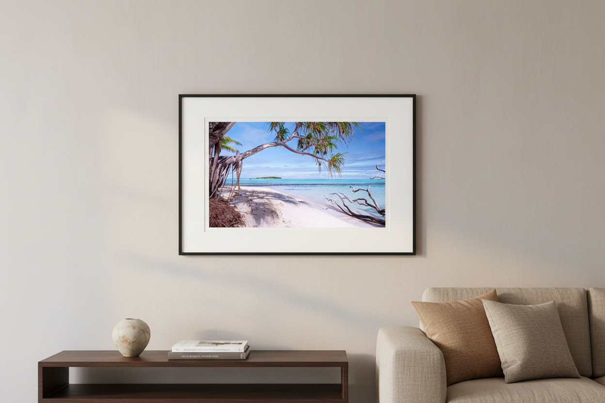 The Cooky's Aitutaki print framed in black with white mat, styled on a neutral wall in a modern luxury interior — Raw Oz Images